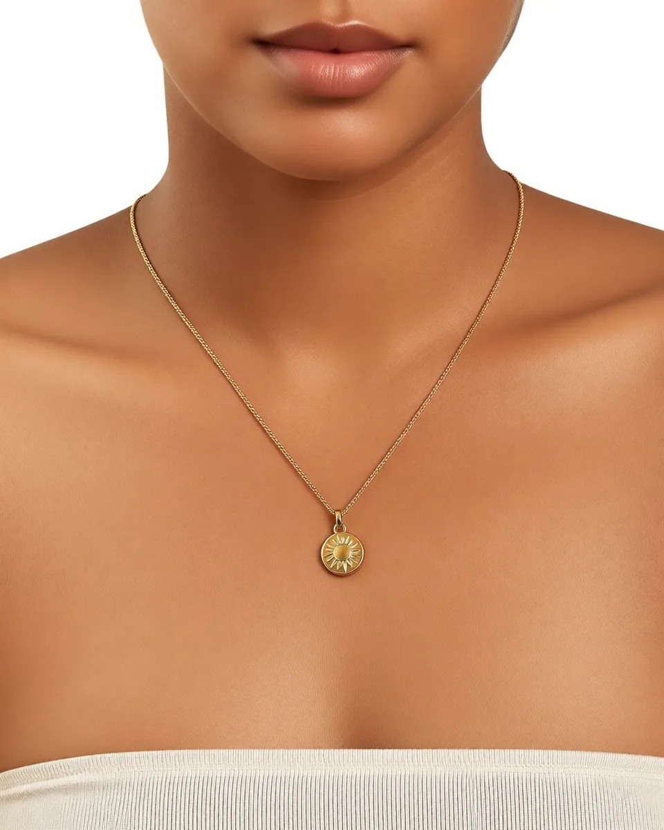 A close crop of the same pendant at the neck, engraving legible.